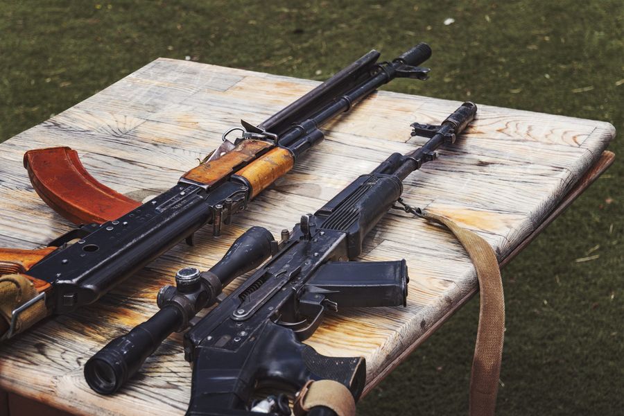 Arms trafficking. different rifles on the counter in the gun shop. clandestine sale of weapons. illegal purchase of weapons. firearms on the table. illegal deal to sell weapons. machinegun